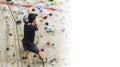 Man practicing rock climbing on artificial wall indoors. Active Royalty Free Stock Photo