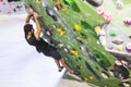 Man practicing rock climbing on artificial wall indoors. Active Royalty Free Stock Photo