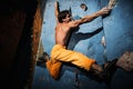 Man practicing rock-climbing on a rock wall Royalty Free Stock Photo