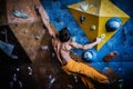 Man practicing rock-climbing on a rock wall Royalty Free Stock Photo