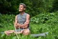 Man practicing yoga and doing ardha padmasana exercise while sitting on lotus position Royalty Free Stock Photo
