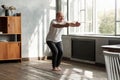 Man practicing yoga indoors at living room doing Chair pose or Utkatasana Royalty Free Stock Photo