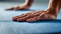 Man practicing yoga or stretching on a textured blue exercise mat focusing on hands and wrist positioning during workout session Royalty Free Stock Photo