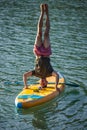 Man practicing yoga on SUP board. Royalty Free Stock Photo