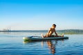 Man practicing yoga on a SUP board Royalty Free Stock Photo