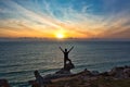 A Man Praising or Worshiping in Front of Ocean at Sunrise