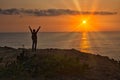 A Man Praising or Worshiping by Ocean at Sunrise