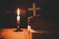 Man praying on the Bible in the light candles selective focus. Beautiful gold background. Royalty Free Stock Photo