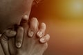 A man praying and close your eyes in praying. Prayer to pray. A young man is holding palms by his lips, whispering a prayer, and Royalty Free Stock Photo