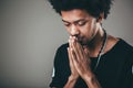 Man praying hands clasped hoping for best asking for forgiveness or miracle