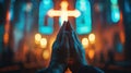 A man is praying with his hands together in front of a cross Royalty Free Stock Photo