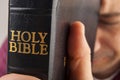 Man Praying Holding the Bible Royalty Free Stock Photo