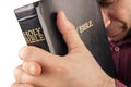 Man Praying Holding the Bible