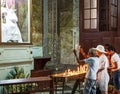 Man praying holding candles up to our lady in church in Cuba Royalty Free Stock Photo