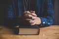 A Man praying holding a Holy Bible. Royalty Free Stock Photo