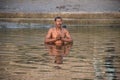 Man praying inside the holy waters of river Ganga in Varanasi, India Royalty Free Stock Photo