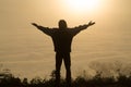 Man praying at sunset mountains raised hands Travel Lifestyle spiritual relaxation emotional concept, Freedom and travel adventure Royalty Free Stock Photo