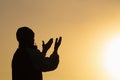 Man praying at sunset mountains raised hands Travel Lifestyle spiritual relaxation emotional concept, Freedom and travel adventure Royalty Free Stock Photo