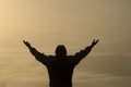 Man praying at sunset mountains raised hands Travel Lifestyle spiritual relaxation emotional concept, Freedom and travel adventure Royalty Free Stock Photo