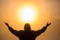 Man praying at sunset mountains raised hands Travel Lifestyle spiritual relaxation emotional concept, Freedom and travel adventure Royalty Free Stock Photo