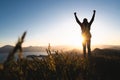 Man praying at sunset mountains raised hands Royalty Free Stock Photo