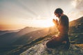 Man praying at sunset mountains Royalty Free Stock Photo