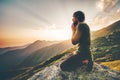 Man praying at sunset mountains Travel Lifestyle Royalty Free Stock Photo