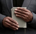 man praying to God with hands held together with people sock image stock photo