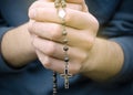 Man prays with a rosary