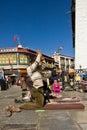 A man prays to Jokhang Temple in Barkhor Square, Lhasa Tibet Royalty Free Stock Photo