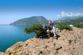 A man of pre-retirement age sits on a rock above the sea Royalty Free Stock Photo