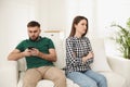 Man preferring smartphone over his girlfriend at home. Relationship problems