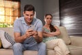 Man preferring smartphone over spending time with his girlfriend. Jealousy in relationship