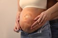 Man, pregnant woman and baby on beige background, closeup view of belly. Double exposure Royalty Free Stock Photo