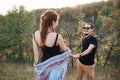 Man and pregnant woman hugging holding hands on the background of wild nature, autumn. love story Royalty Free Stock Photo
