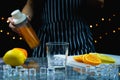 man prepare ice in glass near slice fresh lemon and orange on table Royalty Free Stock Photo