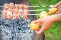 Man prepares barbecue meat with potatoes Royalty Free Stock Photo