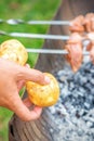 Man prepares barbecue meat with potatoes Royalty Free Stock Photo