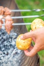 Man prepares barbecue meat with potatoes Royalty Free Stock Photo