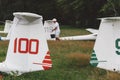 Man prepares and checks gliders parked in the field.