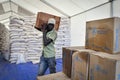 A man prepares food rationing in Kule refugee camp in Ethiopia