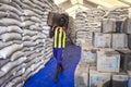 A man prepares food rationing for refugees to Kule refugee camp in Ethiopia