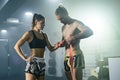 Man preparing bandages for woman Muay Thai boxer getting ready for fight