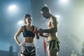 Man preparing bandages for woman Muay Thai boxer getting ready for fight
