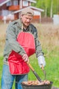 Man preparing barbecue on the lawn bbq Royalty Free Stock Photo