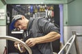 Man preparing a bicycle wheel with masking tape to paint it in his workshop