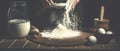 Man preparing bread dough on wooden table in a bakery close up. Preparation of Easter bread. Royalty Free Stock Photo