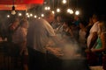 Man preparing burgers on street at local festival