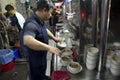 Man preparing Chinese soup for customer