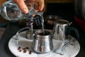 Man preparing classic Italian coffee in the mocha in the kitchen, pouring water into the coffee maker. Coffee brake. Morning habit Royalty Free Stock Photo